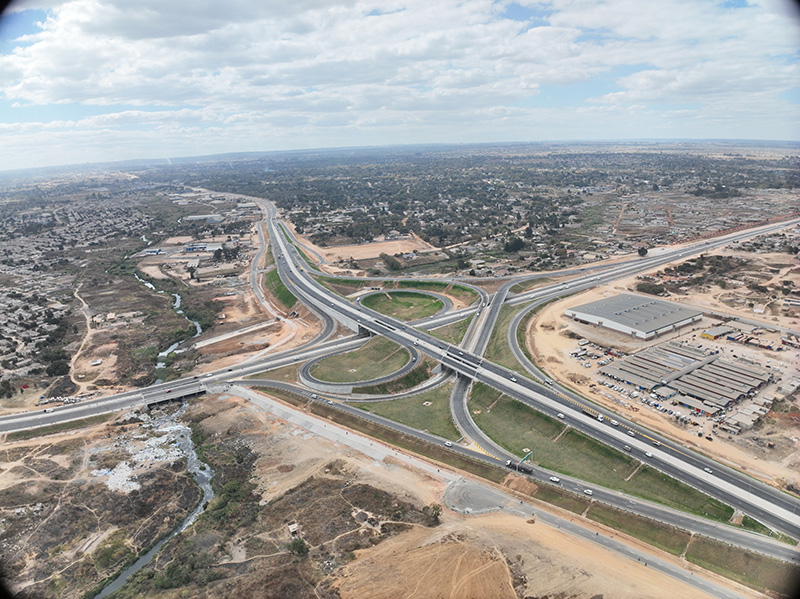 Aerial view of the Mbudzi Interchange in Harare, a grade separated cloverleaf interchange with loop and ramp roadworks